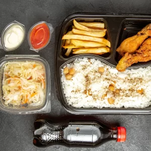 Chicken Over Rice with Fries and can of Soda